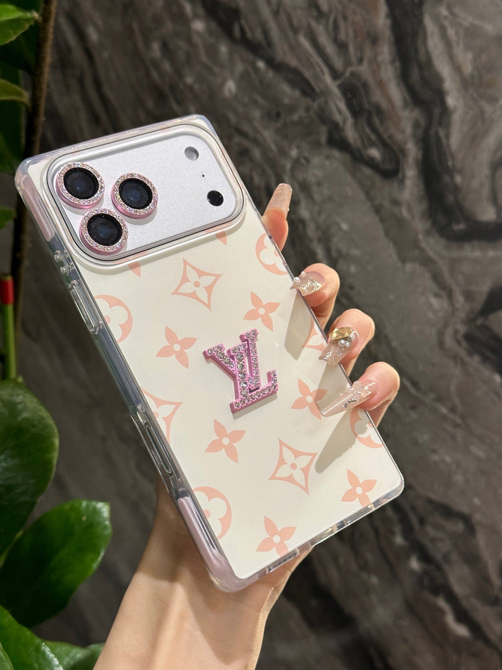 White pastel monogram iPhone case with a raised center emblem