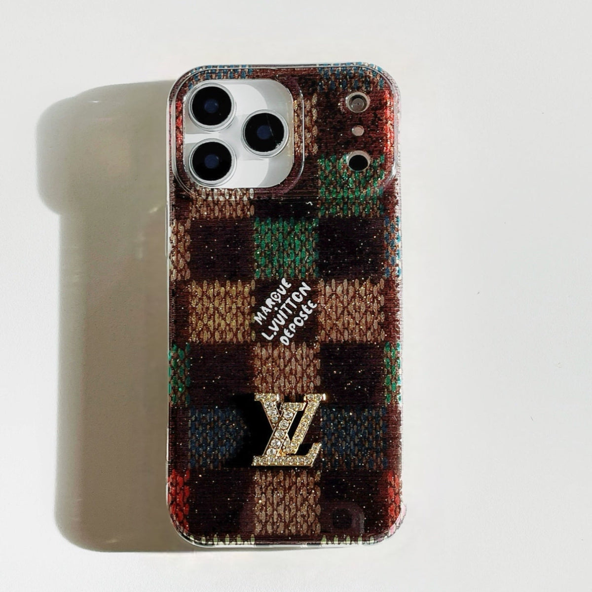 Multicolor fuzzy checked iPhone case with a raised monogram detail