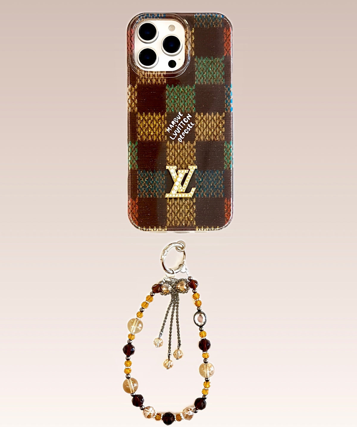 Multicolor checked iPhone case with a decorative wrist charm shown from another angle