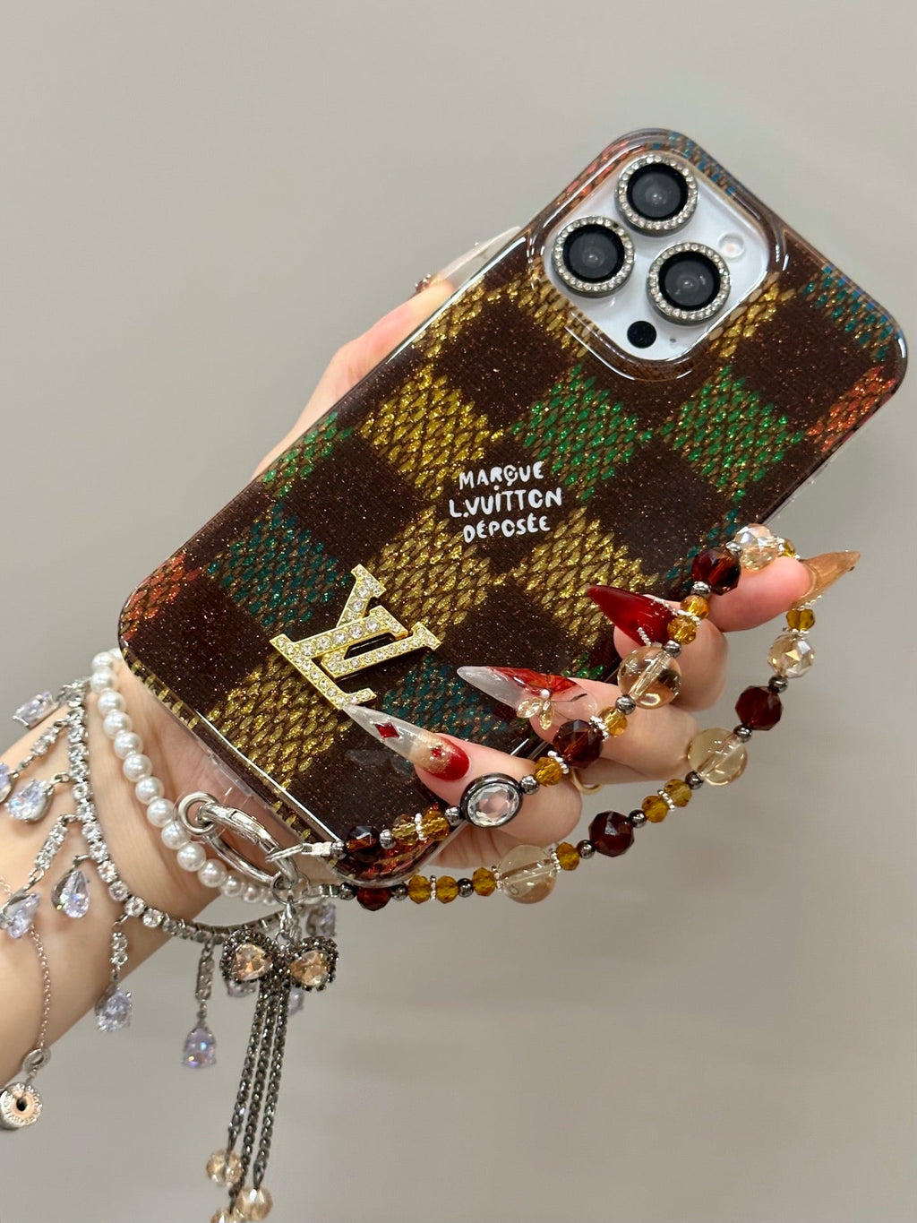 Multicolor checked iPhone case with a decorative wrist charm