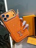Orange dotted iPhone case with a back card pocket and raised monogram detail