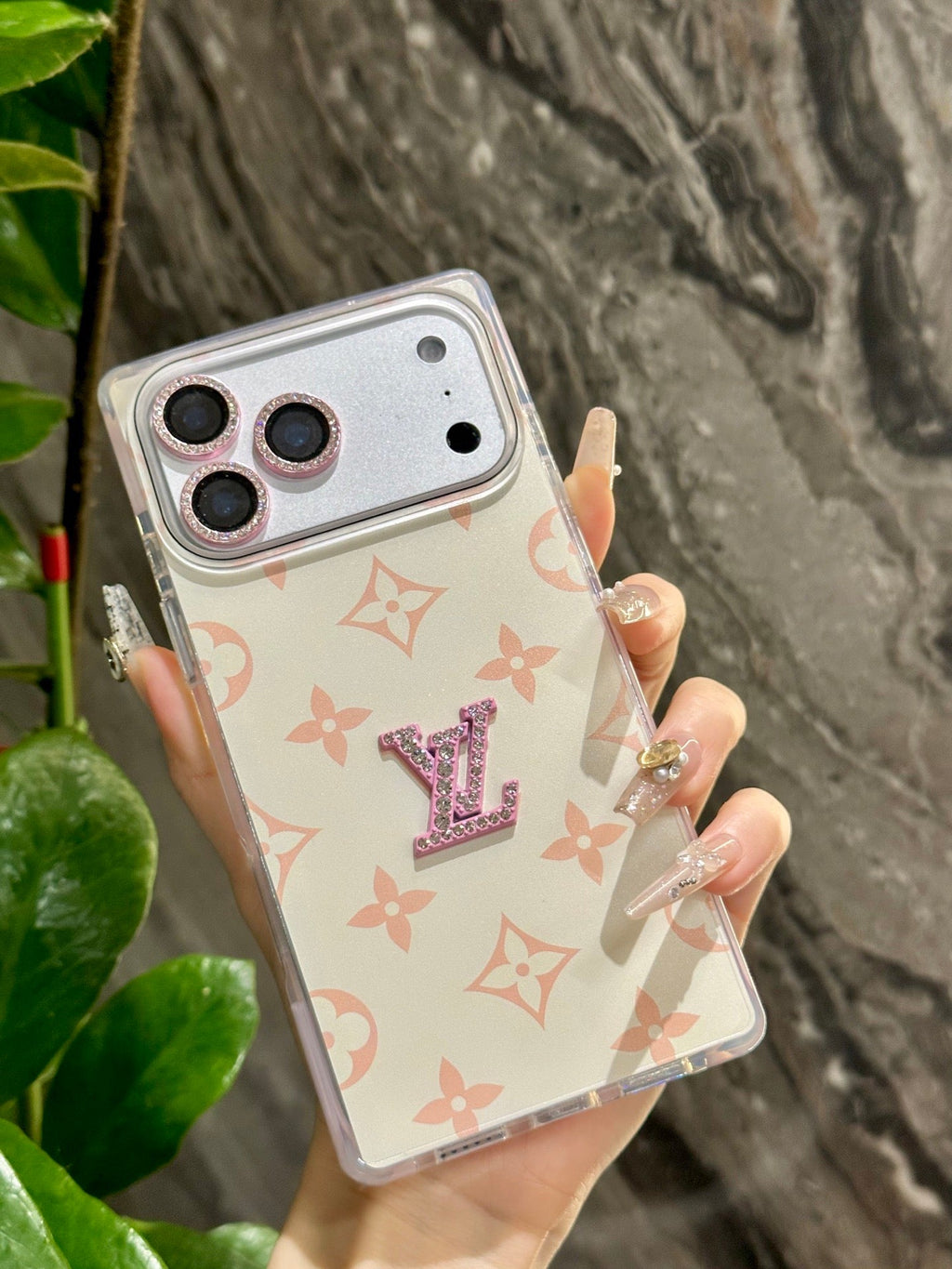 White pastel monogram iPhone case with a raised center emblem shown from another angle