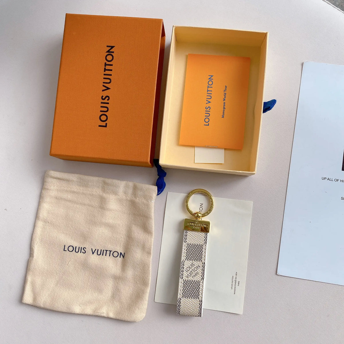 White and gray checkered key holder displayed with packaging