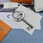 Silver-tone key-shaped charm with oval head and LV detail