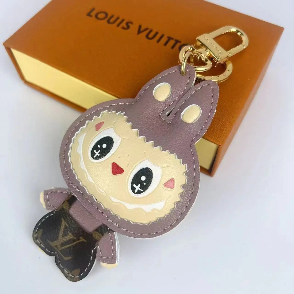 Muted brown Labubu keychain with dark monogram body