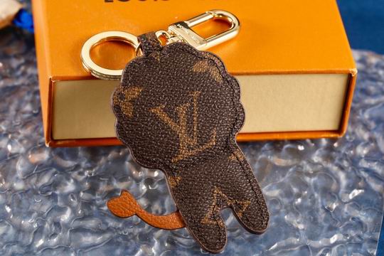 Reverse of lion charm showing monogram pattern and curved tail