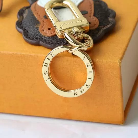 Close-up of lion keychain clasp and engraved round ring