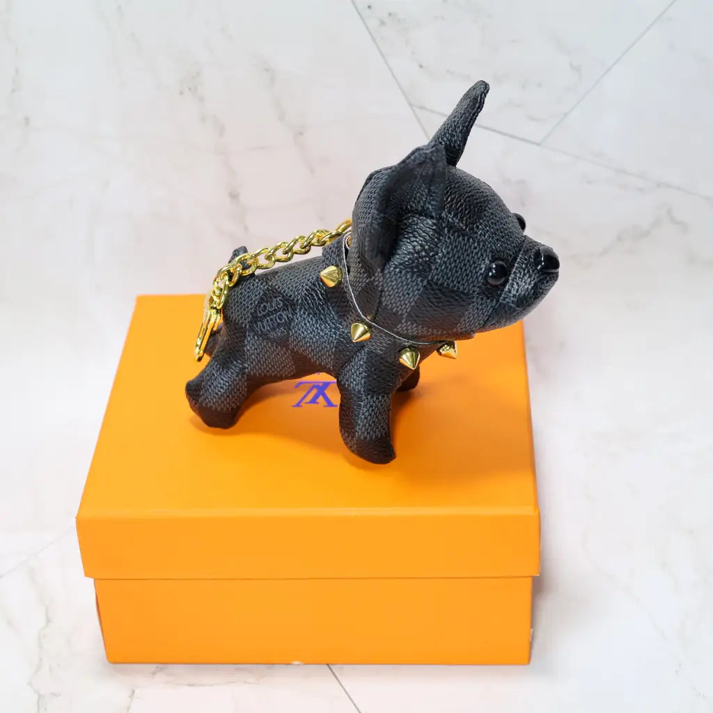 Black checkered bulldog keychain with gold-tone chain and clasp