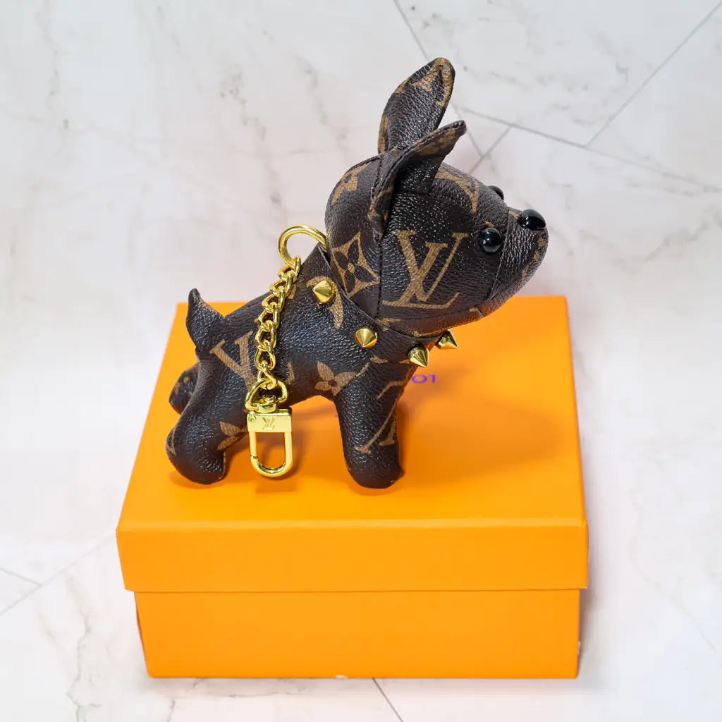 Brown monogram bulldog keychain showing its studded collar