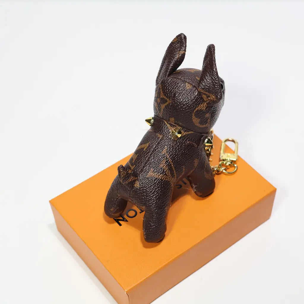 Rear view of brown dog keychain with pointed ears