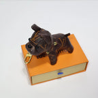 Top view of monogram dog keychain on an orange box
