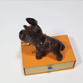 Brown monogram dog keychain shown in side profile