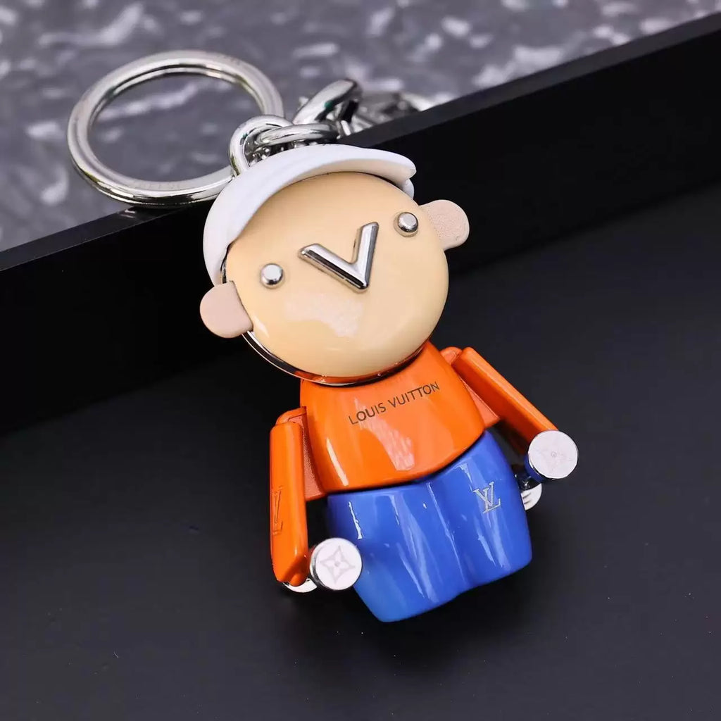 Close-up of character keychain with white cap and V-shaped nose
