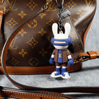Blue bunny charm attached to a brown monogram bag