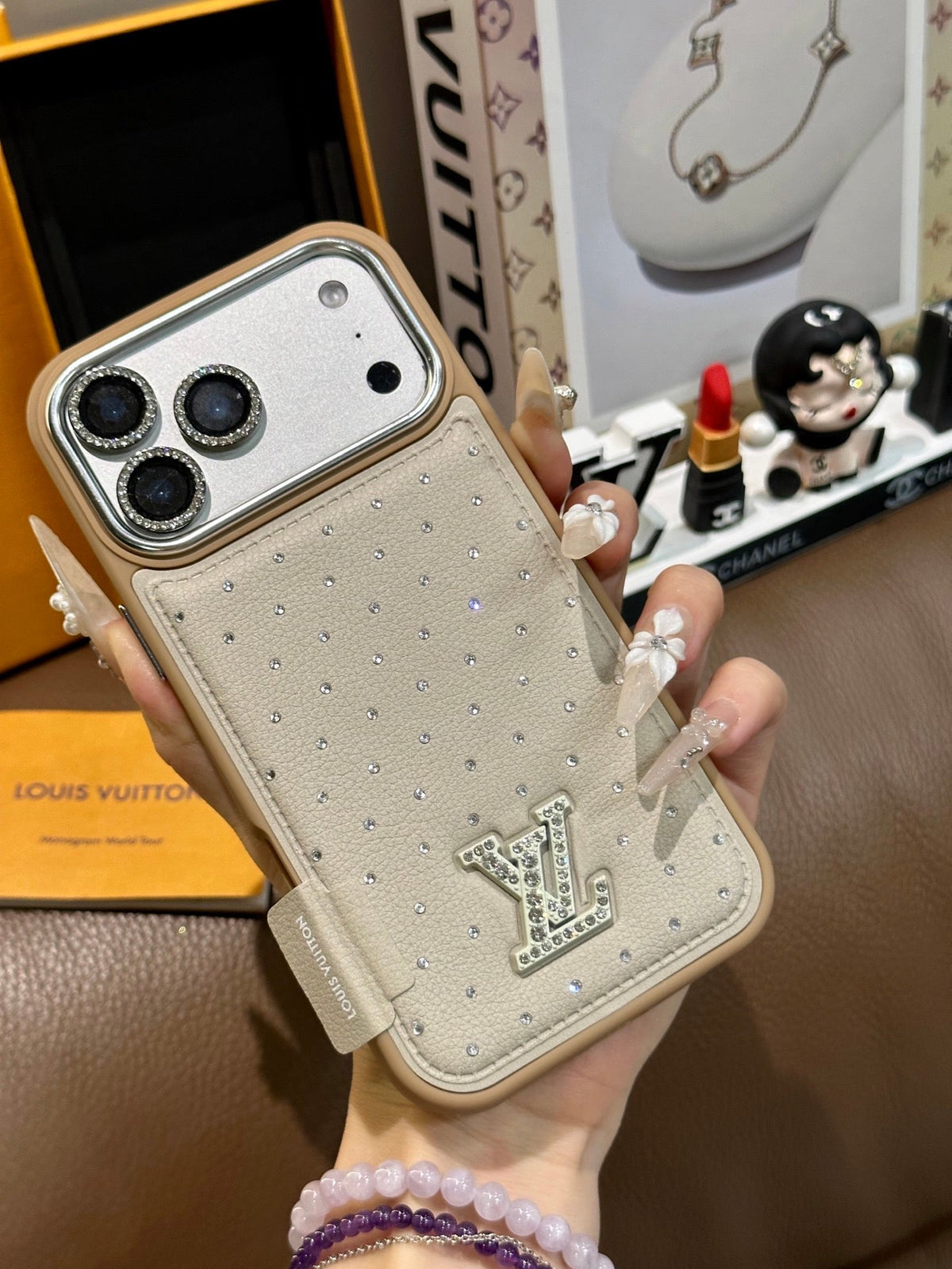 Cream dotted iPhone case with a back card pocket and raised monogram detail