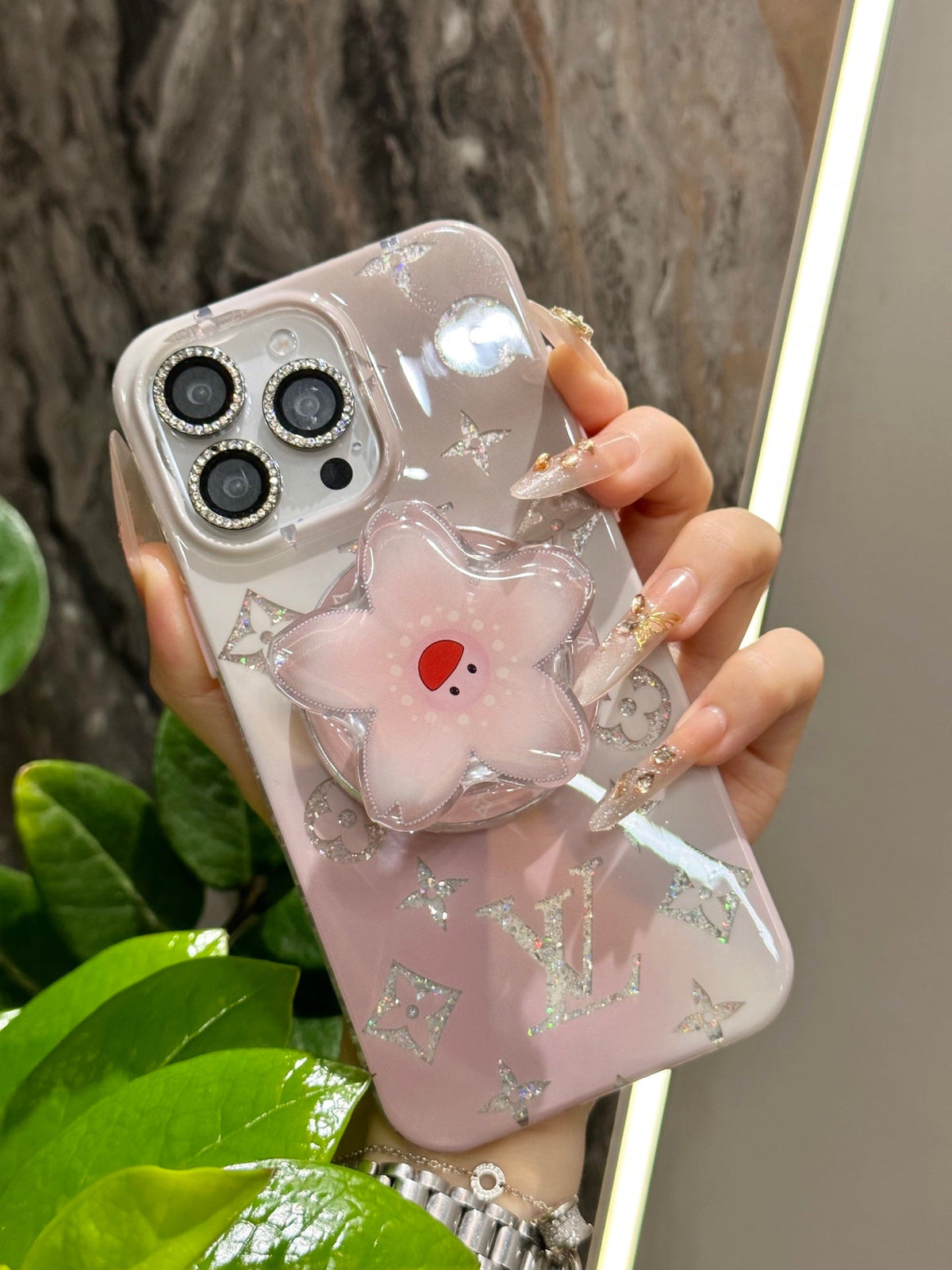 Pale pink iPhone case with a three-dimensional flower grip