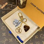 Cube keychain showing gold-tone heart backing and round LV charm