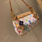 Bright floral LV keychain attached to a white multicolor bag