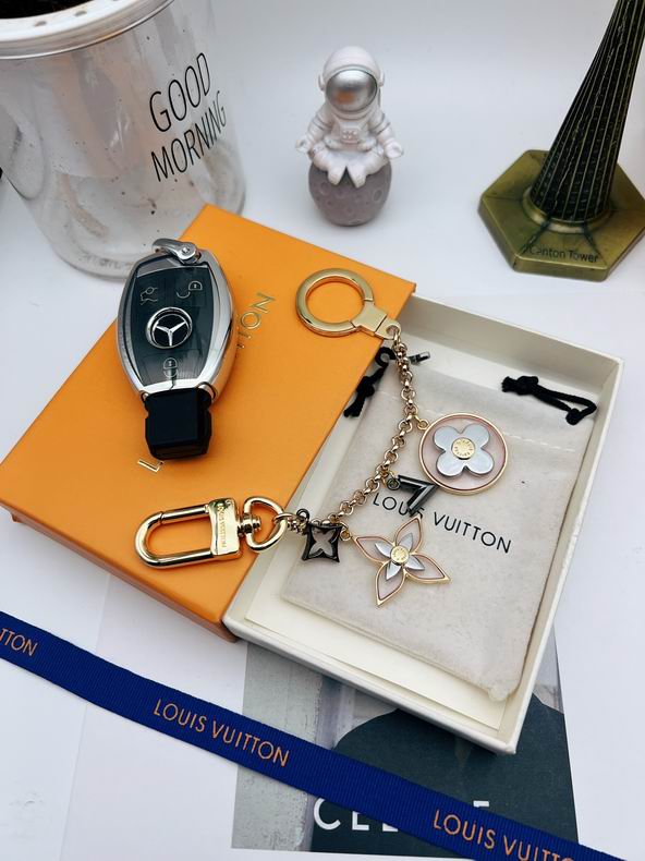 Floral chain keychain arranged beside a black car key