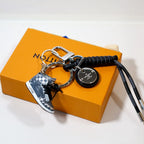 Black sneaker keychain with braided cord and round pendant