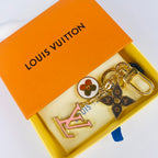 Pink LV monogram keychain displayed inside an orange box